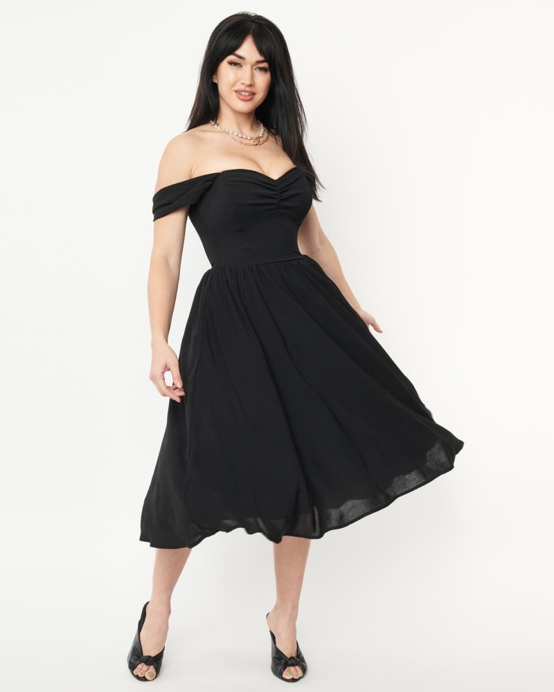 Front of a model wearing a size 1X Unique Vintage Black Off Shoulder Swing Dress in Black by Unique Vintage. | dia_product_style_image_id:300880